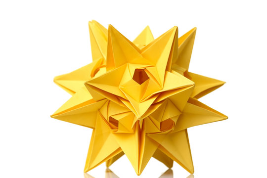 Yellow star origami figurine isolated on white background. Astronomical bodies. Fancy artwork, school project.