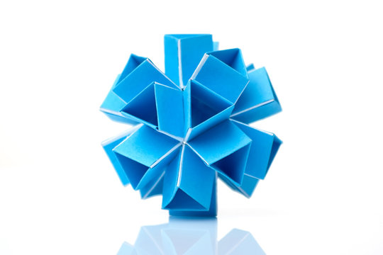 Blue kusudama model on white. Amazing geometry of origami creation. Japanese art of folding paper.