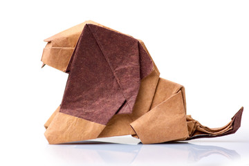 Origami lion on white background. Wet-folding technique, paper sculpting art. Craft exposition concept.