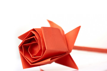 Rose flower made of paper. Beautifully folded bulb, made of red paper. Origami crafting project for beginner.