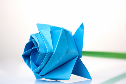 Beautiful blue flower origami. Learning art of folding paper. Child's project dedicated to International Women's day.