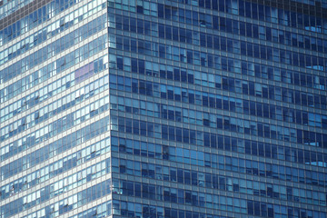 close up on modern office building skyscraper with blue glass wall