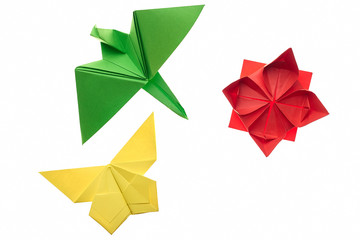 Crane, butterfly and lotus origami on white. Red, green and yellow paper. Hand crafting project...