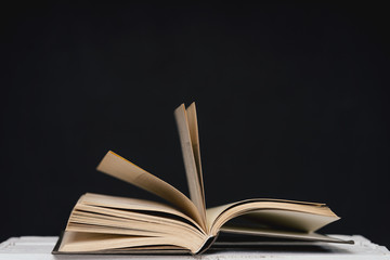 Open book on white table top. Concept: back to school or education