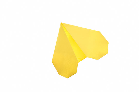 Yellow heart isolated on white. Simple origami art project for Valentine's day. Fun activity, easy crafts for kids.
