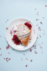 Freshly baked croissant on a white plate