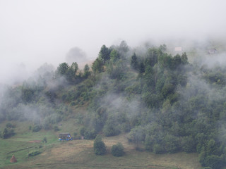 Fog at the village in the carpatian mountains