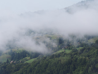 Fog at the village in the carpatian mountains