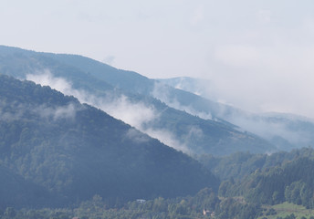 Fototapeta premium Fog at the village in the carpatian mountains