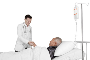 Fototapeta premium Doctor shaking hand with elderly patient