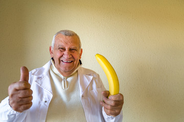 doctor holding banana as impotence concept