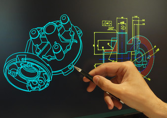 engineer working at computer on mechanical piece design