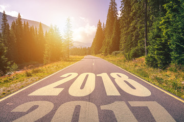 Empty asphalt road and New year 2018 concept. Driving on an empty road in the mountains to upcoming...