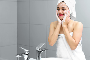 Beautiful woman cleaning her face