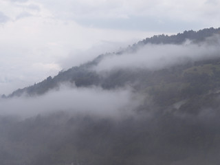 Naklejka na ściany i meble Fog at the village in the carpatian mountains
