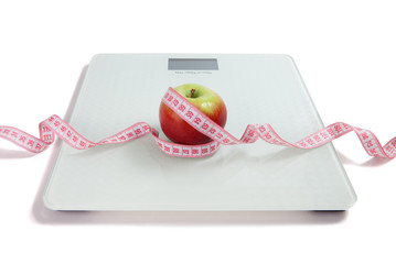 An apple on the scales. Weight control. Losing weight.