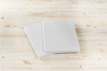 Mockup of magazine, poster, A4 brochure, catalog or flyer isolated on white wooden background. Blank page top view for use in design, mockups and simulations.