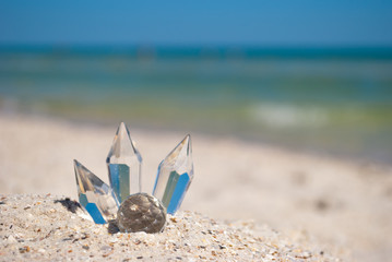 beautiful transparent glass crystals on yellow sand summer beach sea shore blue sky vacation rest weekend