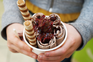 Child is holding hocolate ice cream.