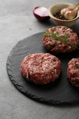Raw minced burger meat on slate