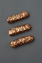  golden eclairs with caramel, peanuts, and chocolate icing