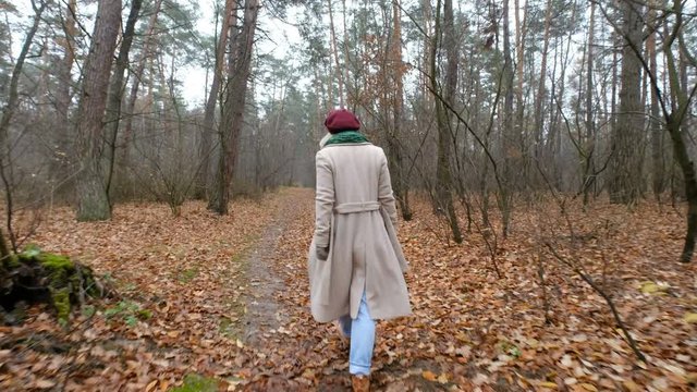 scared woman  trying to escape running away from man chasing her in a forest
