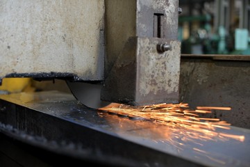 metalworking industry: finishing metal working on horizontal surface grinder machine with flying sparks