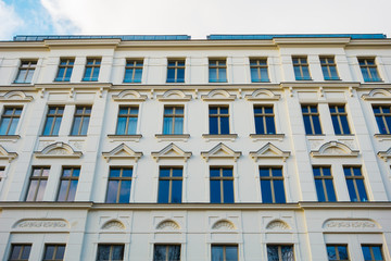 white residential facade with blue windows