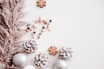 Woman Christmas background on white. Frosty pine cones, silver colored decoration balls, faux fur, jewelry. Copyspace for text, overhead, horizontal
