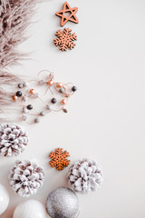 Woman Christmas background on white. Frosty pine cones, silver colored decoration balls, faux fur,...