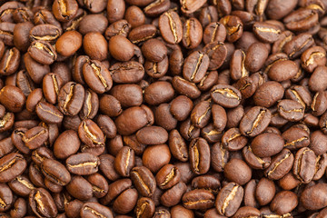 Roasted brown coffee beans as background