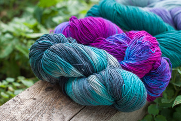 Colourful wool yarn balls on the wooden background