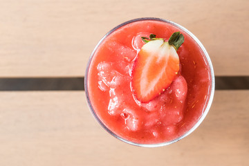 Close up strawberry smoothie with fresh strawberry on wooden table