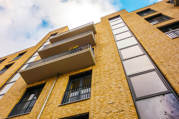 modern brick apartment building with brown facade