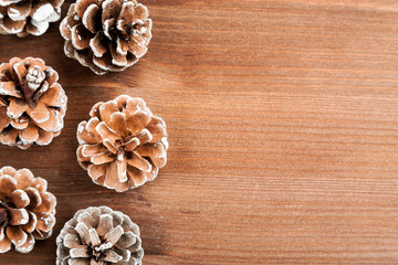 Dry fir tree cones on a wooden table, closeup