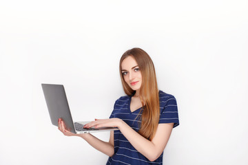 Cheerful attractive caucasian blonde woman with using slim elegant notebook computer isolated on a white background