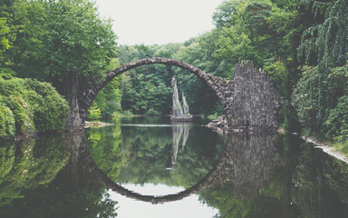 Rakotz bridge (Rakotzbrucke) also known as Devil's Bridge in Kromlau, Germany. Reflection of the bridge in the water create a full circle.