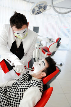 An evil dentist treats a tooth to a patient in a dental chair. Fear of the dentist.