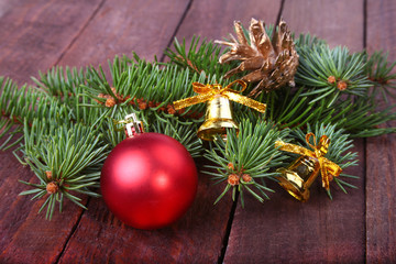 Fototapeta na wymiar Christmas decoration with Beautiful colorful balls, christmas tree and fir cones on wooden background.