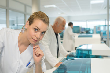 nurse posing next to machine