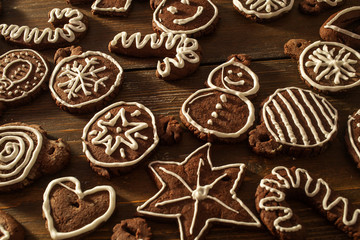 Traditional homemade Christmas ginger and chocolate cookies decorated with white sugar painting