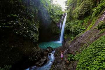 Woman near Aling-aling waterfal on Bali, Indonesia