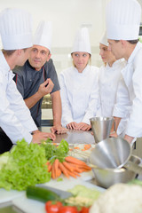Chef talking to team of apprentices