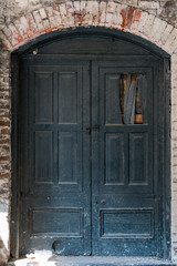 Fototapeta na wymiar Old Damaged Wooden Doors with Brick