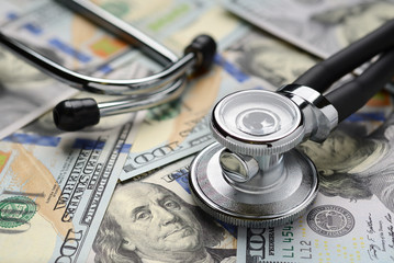 Medical stethoscope and dollar bills