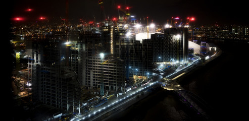 Fototapeta na wymiar London River Thames night skyline by Canary Wharf and the North Greenwich redevelopment