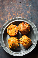 Indian spicy vegetable pakoras on metal plate 
