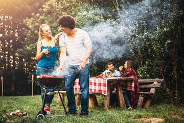 Young people having fun making barbecue
