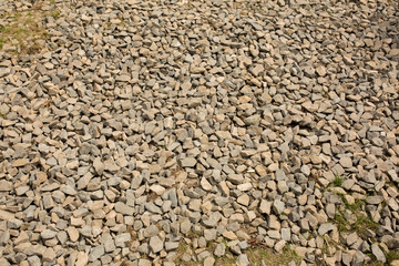 Background of crushed granite stones with grass