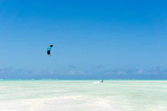 kitesurfing on tropical sea at low tide in Jambiani, Zanzibar, Tanzania Africa